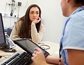 woman at surgery having annual pill check